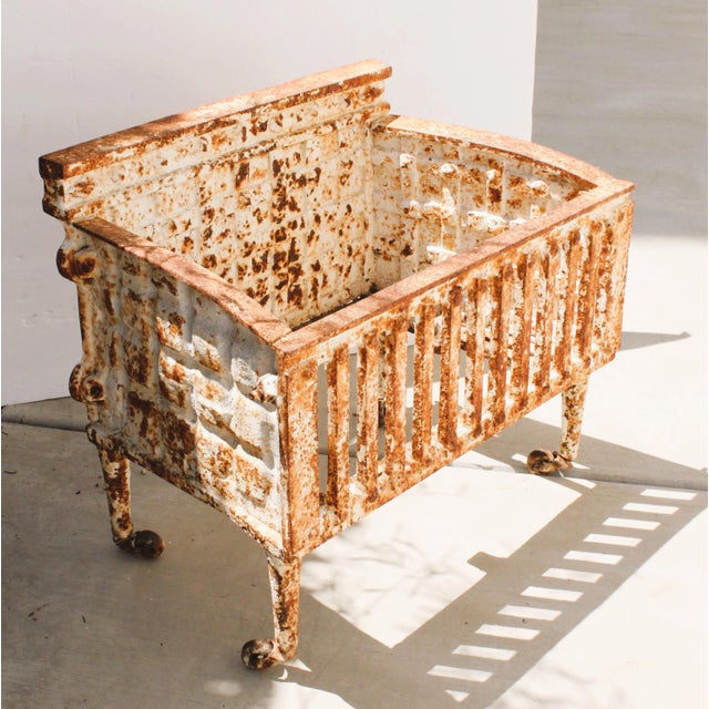 Exceptional 1880's French cast iron firewood basket with caster wheels. We're crushing on it's lovely handcrafted design,...