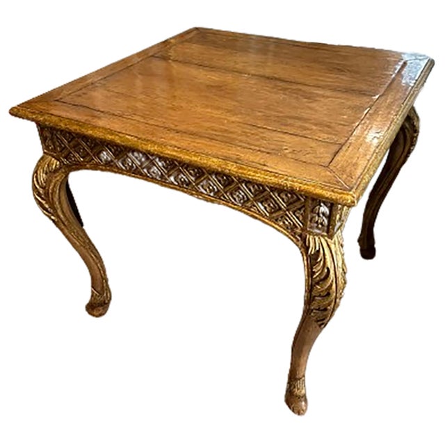 A handsome antique giltwood table. Cabriole legs and animal hoof feet. Diamond pattern and floral carvings on the side....