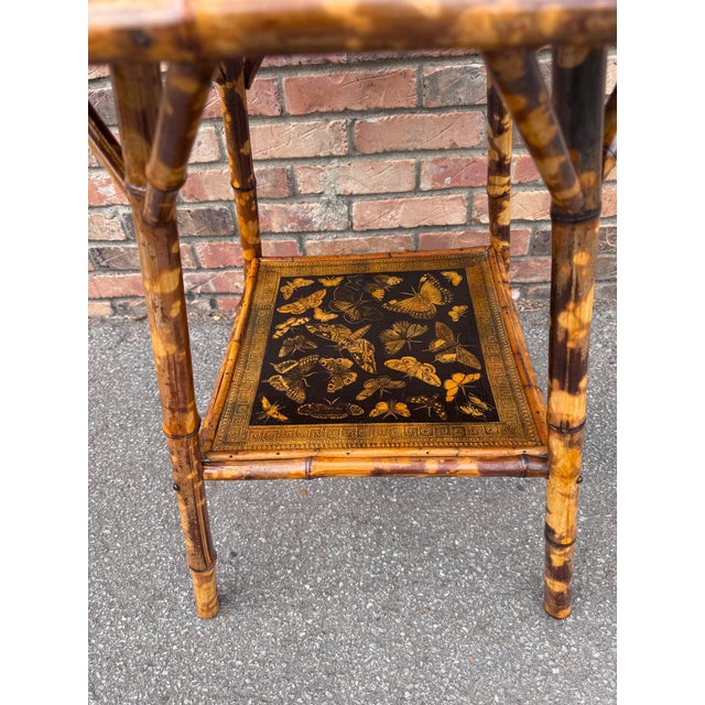 This 19th Century English Bamboo Side table features a delightful variety of butterflies decoupaged onto the top and lower...