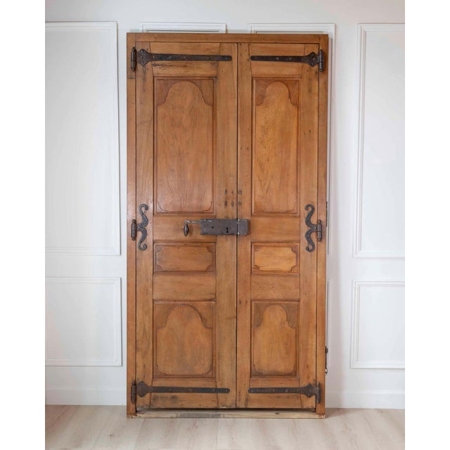 A nineteenth-century French walnut communication door of double-leaf, double-sided construction. The double-leaf format —...