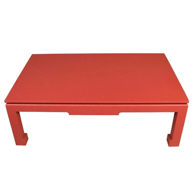 A chic Ming-style coffee table, wrapped in textured raffia and painted a vibrant red for a modern twist on a classic...