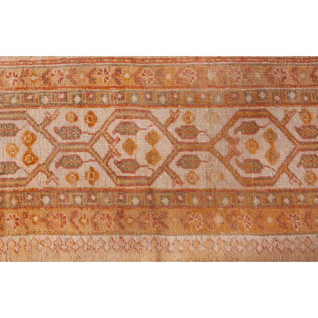 A stunning example of early 20th-century Anatolian textile artistry, this antique Turkish Oushak rug encapsulates the...