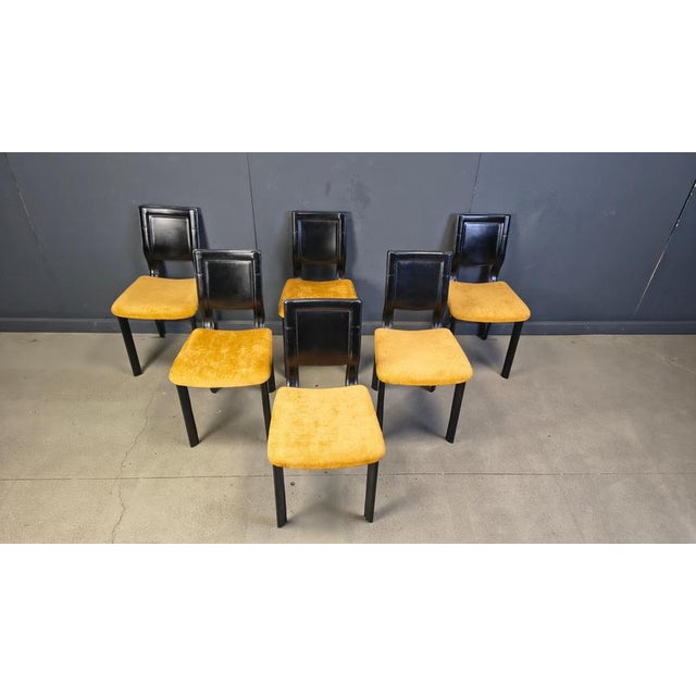 Set of 6 black leather dining chairs with newly upholstered yellow fabric chairs. beautiful sleek and timeless design. The...