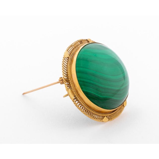 14K Yellow Gold Malachite Brooch Pendant, featuring one bezel set oval malachite cabochon, weighing approx. 75.00 carats,...