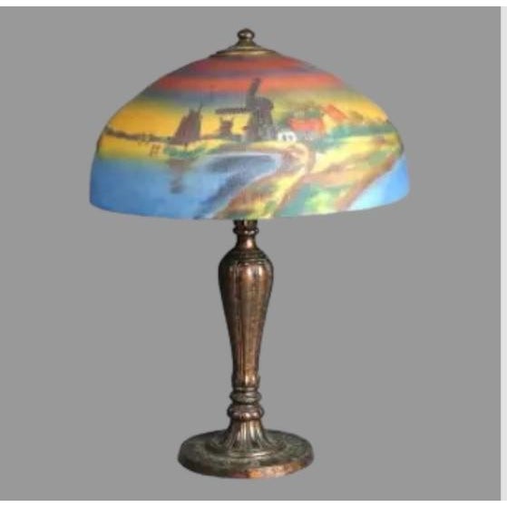 An antique Arts and Crafts table lamp with domed glass shade having a textured exterior and reverse painted interior...