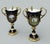 An Exceptionally fine and quite rare pair of hand painted Three Handle Coalport Trophy or Loving Cups Urns Vases often...