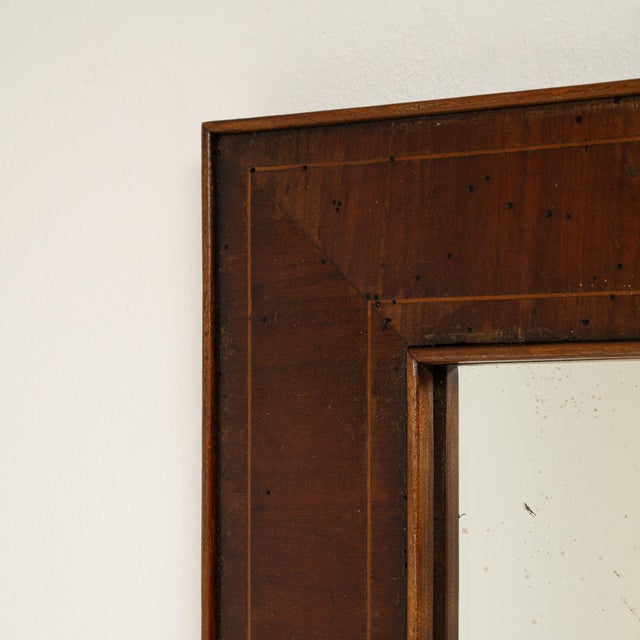 This piece presents as a mirror, distinguished by dark walnut frame, rectangular. Dating to 19th Century and originating...