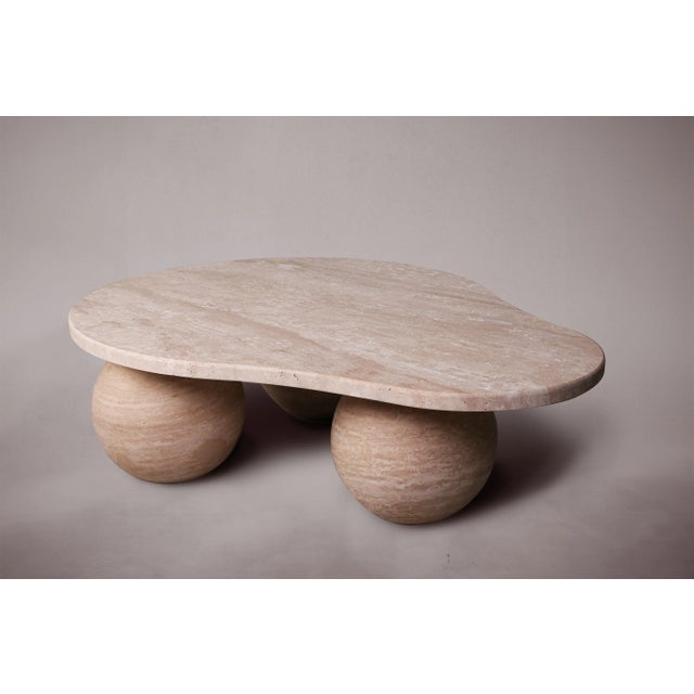 Add a touch of unique elegance to your living space with our exquisite three-legged travertine coffee table. Crafted from...