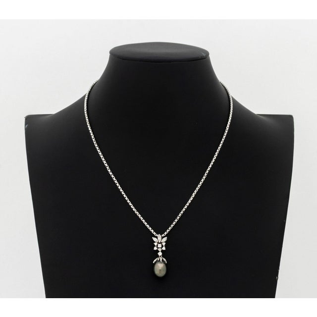 14K White Gold, Tahitian Pearl, and Diamond Necklace and Earrings Set, featuring one necklace with fixed pendant decorated...