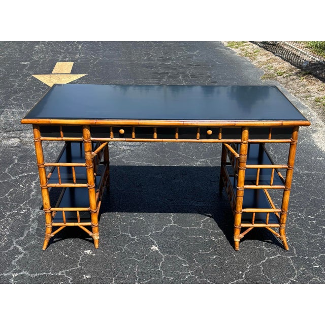 A striking vintage desk by Milling Road for Baker Furniture, blending Hollywood Regency and British Colonial influences...