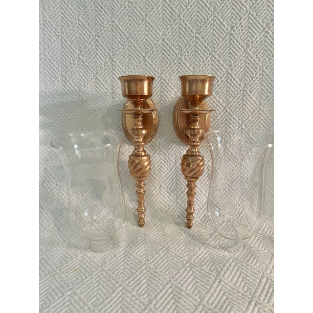 These solid cast brass wall sconces were imported by Gatco in the 1960’s or mid 20th century. The wall mount is an oval...