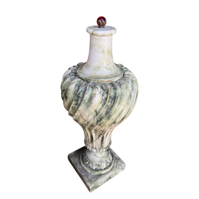 An incredible antique piece with fluted carved body. The lid features a red glass ball with bronze. Measures 24” tall x 9”...