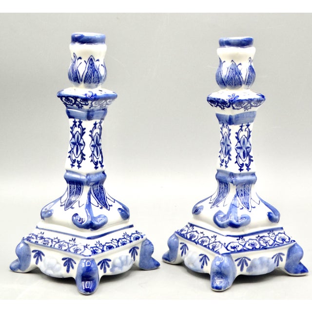 Lovely pair of Mid Century blue and white Delft style candlesticks. They are delicate in design and hand painted with soft...