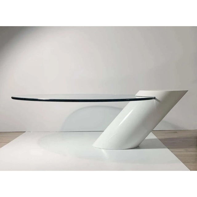 Oval glass set into a lacquered angled Wood base. Designed by J. Wade Beam for Brueton.