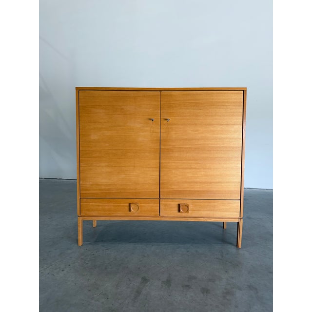 Mid Century Scandinavian Wood Locking Door Storage Cabinet. Light blonde Ash wood with offset square pulls with recessed...