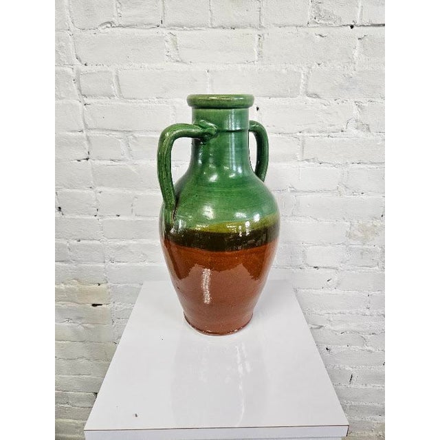 Stunning early 20th-century French glazed ceramic vessel. Featuring a classic amphora silhouette with traditional twin...