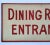 Circa 1950s hand lettered one sided Dining Room Entrance sign with red lettering and border on masonite. Sign has holes...