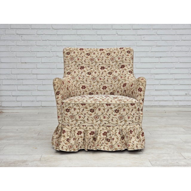 1970s, Danish armchair. Original furniture jacquard fabric, ash wood legs, springs in the seat. Manufactured by Danish...
