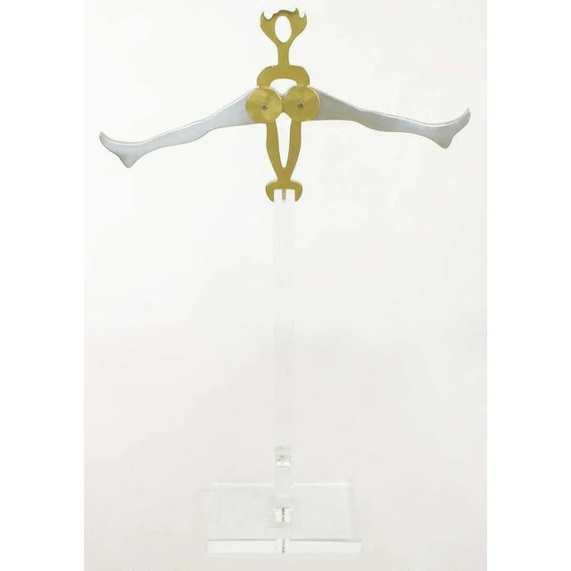 Brass and polished aluminum sculpture of a gymnast mounted on an acrylic stand by sister collaborators Arleen Eichengreen...