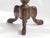 An antique carved round table made out of solid wood. The side table is standing on three wooden legs with beautiful...