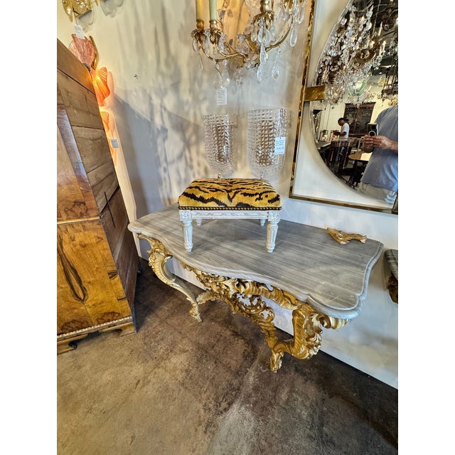 This product is an antique 19th Century French Louis XVI stool, featuring painted wood with intricate carvings. The piece...