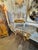 This product is an antique 19th Century French Louis XVI stool, featuring painted wood with intricate carvings. The piece...