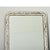 A French 19th century Louis Philippe mirror in a tall, silver gilt frame enhanced by dark oxidation and craquelure texture...