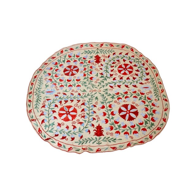 Add a touch of exotic elegance to your dining experience with our round Suzani embroidered Tablecloth. Originating from...
