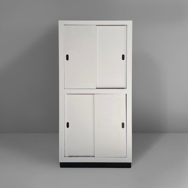 Italian modern wardrobe in light grey and black wood, 1960s Rectangular cabinet in light gray-white and black wood. The...