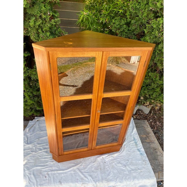 Vintage Danish teak corner display cabinet with glass door and 3 1/2 wood adjustable shelves inside. Perfect for a bar...