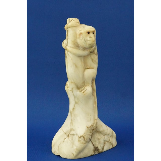 Description of the object: Entirely hand-carved and finely polished marble sculpture depicting a macaque monkey on a...