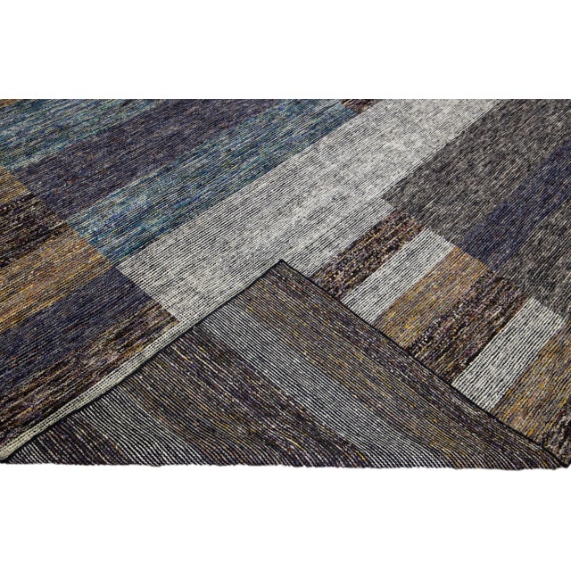 Beautiful modern Apadana's Safi Collection hand-knotted wool rug with an earthy colors field. This Modern rug has blue,...