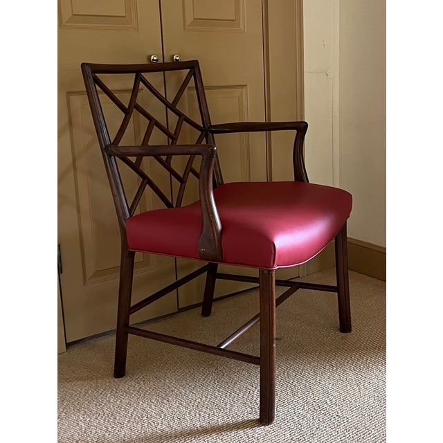 English Georgian Chinese Chippendale style mahogany cockpen armchair upholstered with red vegan leather curved saddle...