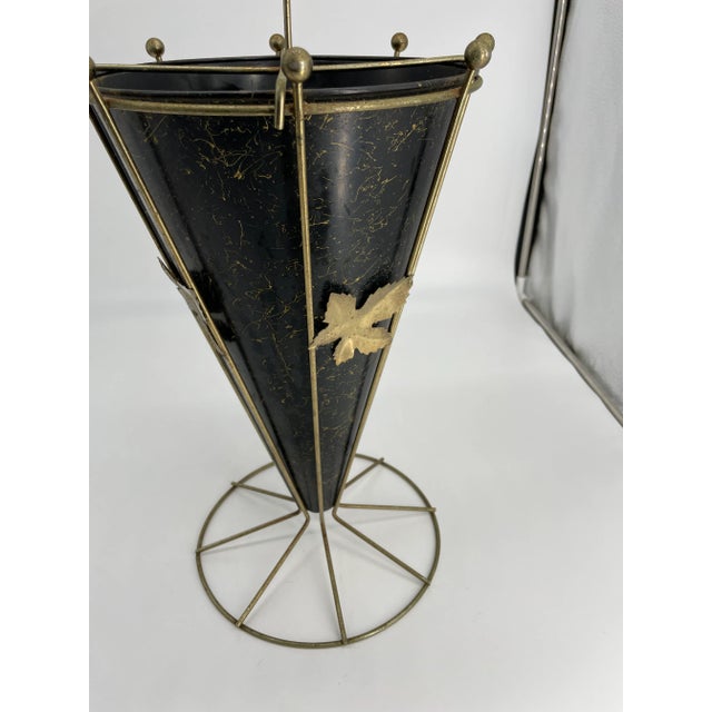 Eye catching mid-century modern umbrella stand. Sturdy brass frame shaped like an umbrella with a black metal tub with...