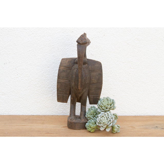 A stunning piece of African art, this antique Senufo hornbill statue is hand-carved from a single piece of wood. This...
