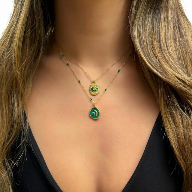 Green Enamel Evil Eye Gold Pendant Happiness Necklace is a radiant and meaningful accessory designed to evoke joy,...