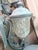 An elegant matched pair of wall sconces with ornate brass-finish candelabra bases and large glass urn-style shades....