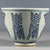 This is a charming vintage porcelain teacup, possibly a "smelling cup"used in tea ceremonies, decorated in the classic...