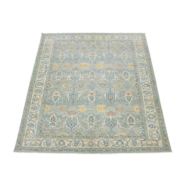 Transform your space with this striking hand-knotted oversized Sultanabad wool rug, featuring a serene light blue...