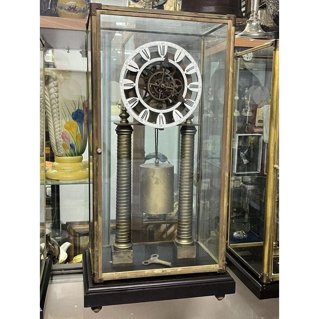 Skeleton Clock with Case And Key. Has key, weight & pendulum Ticking away for a minute and stops so needs attention Sizes...