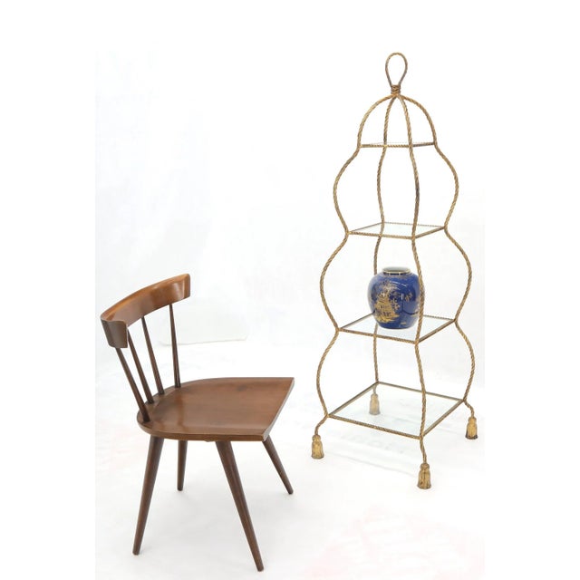 Italian Mid-Century Modern decorative twisted gilt metal rope étagère with glass shelves.