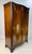 George III style serpentine front wardrobe armoire, crafted in rich, highly figured flame mahogany. This impressive piece...