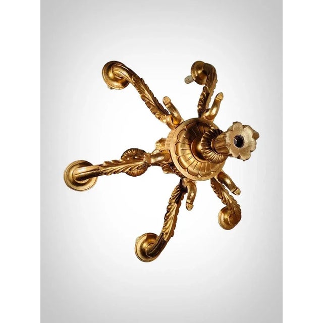 Illuminate your space with sophistication using this elegant ceiling lamp crafted from carved and gilded wood, a true...