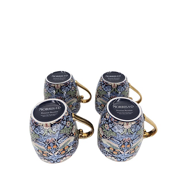 A refined set of four porcelain mugs by Morris & Co., featuring the iconic Strawberry Thief William Morris botanical and...
