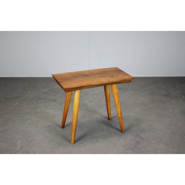 A mid-century stool crafted by ULUV in Czechoslovakia during the 1960s, made from solid cherry wood with beautifully...