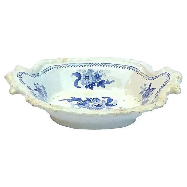 Antique; 19th century, English, blue-and-white, floral-and-butterfly, vide poche with handles. Floral design at the center...