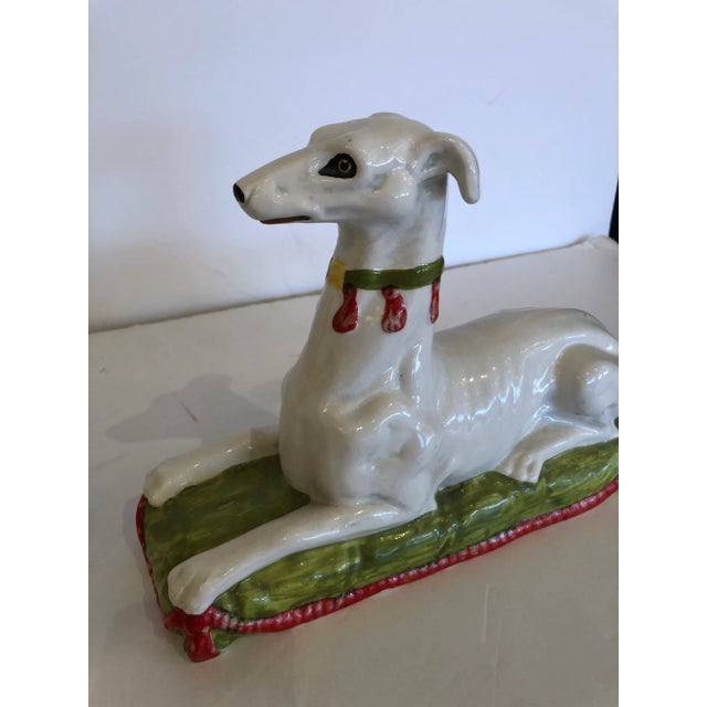 Wonderful eye-catching pair of Italian ceramic whippets regally posed and in a striking color palette of white, orange and...