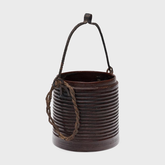 This petite wooden bucket is an early 20th century Chinese tea canister attributed to the Miao people of southern China....