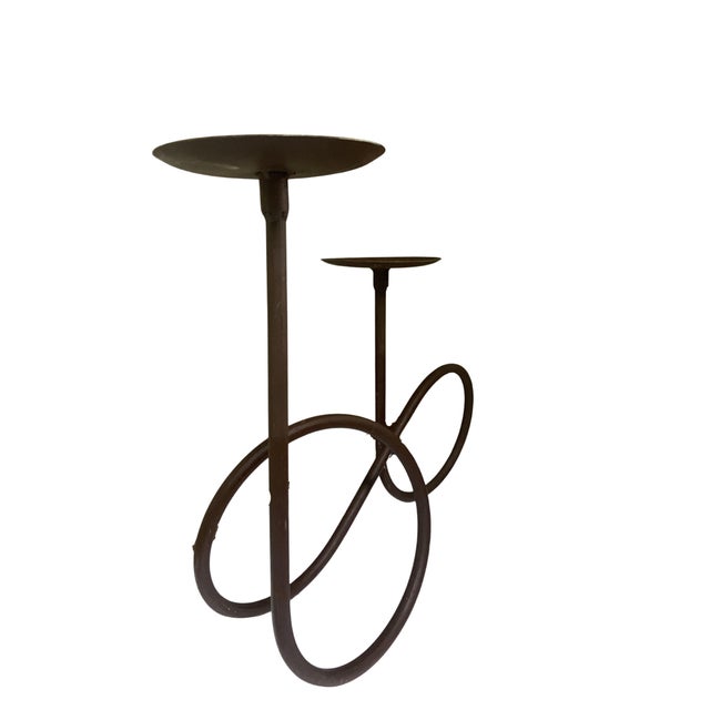Rustic brown metal candle holder for two pillar candles.