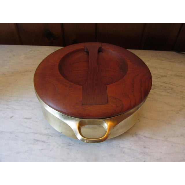 Vintage 1960s chafing pot by Jens Quistgaard for Dansk. Constructed of brass with a steel and teak top. Pot newly...